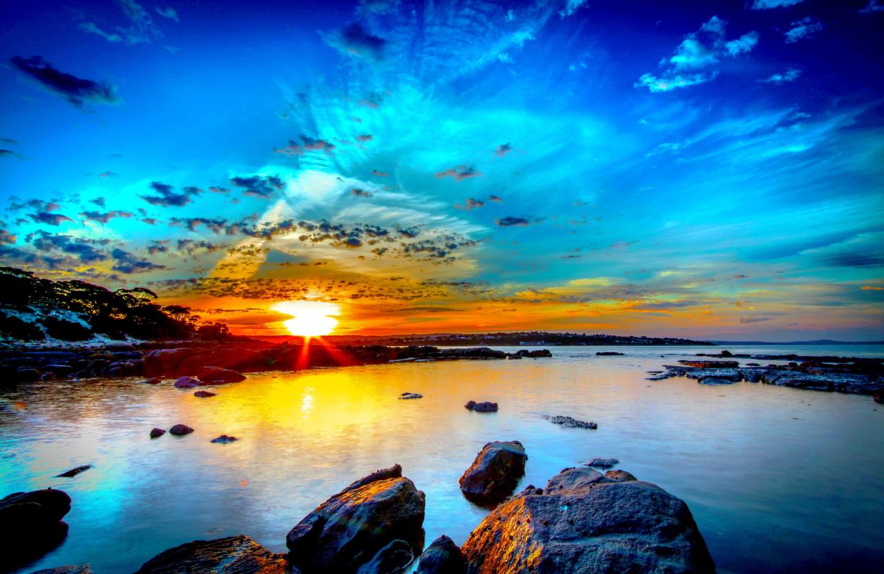 Beautiful Morning Sunrise over Rocks and Water